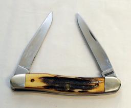 (2) KNIVES A CASE  MUSKRAT 1993 ABCA 1/800 STAG HANDLED FOLDING KNIFE AND A SXM 1993
