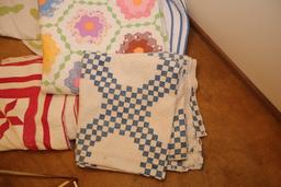 Quilt rack and vintage quilts; quilts show signs of use