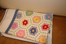 Quilt rack and vintage quilts; quilts show signs of use
