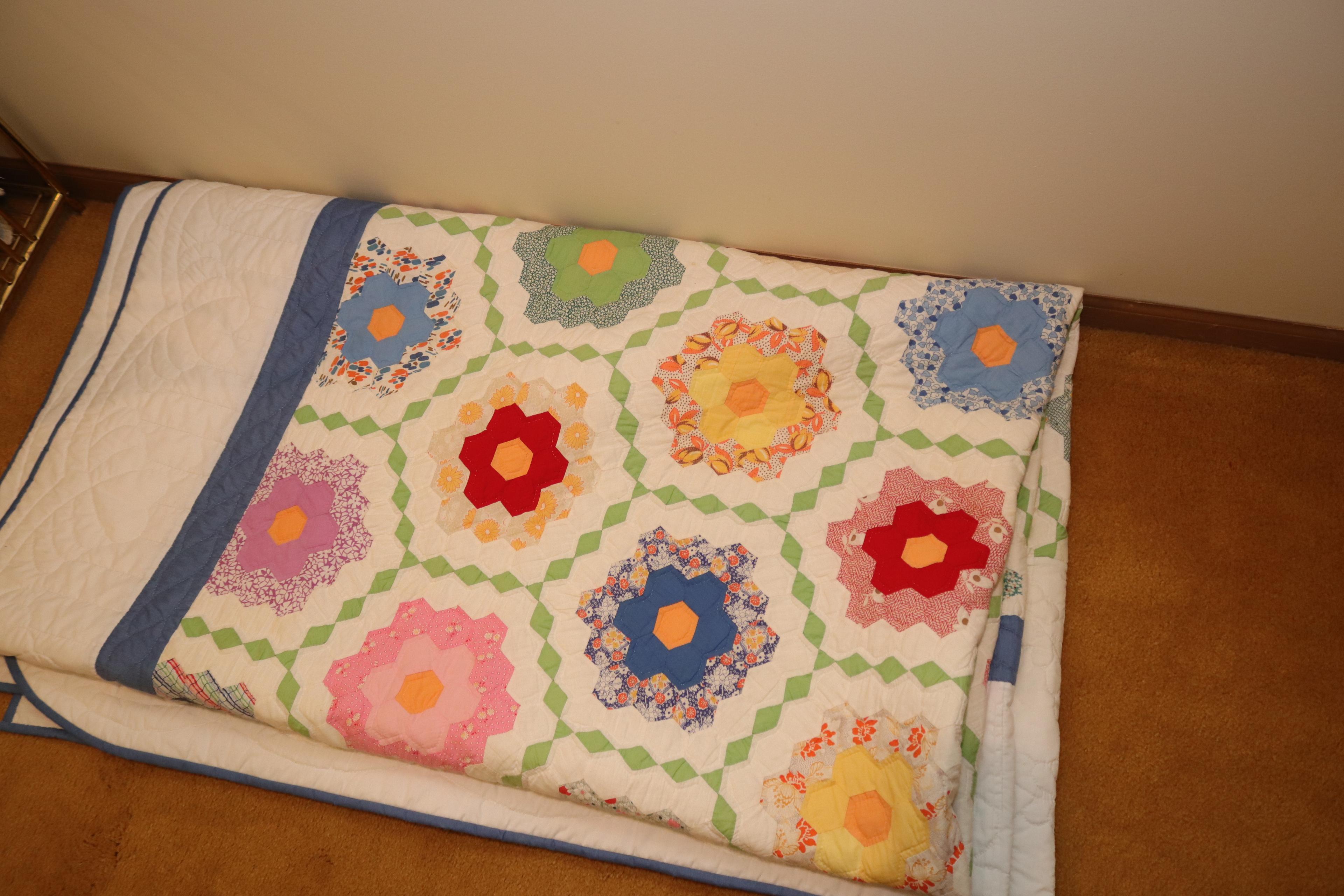 Quilt rack and vintage quilts; quilts show signs of use