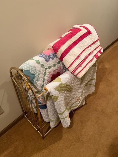 Quilt rack and vintage quilts; quilts show signs of use