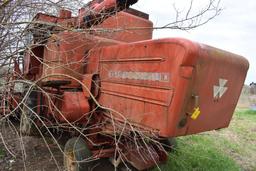MF combine, salvage- sells w/ partial rack of weights sitting under it