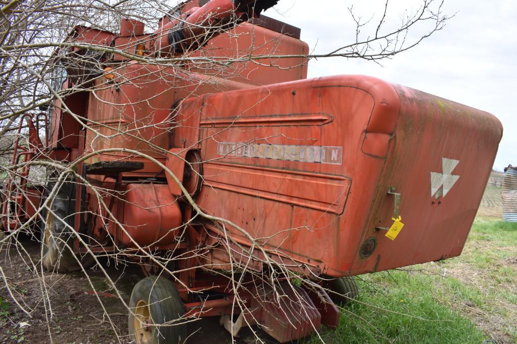 MF combine, salvage- sells w/ partial rack of weights sitting under it