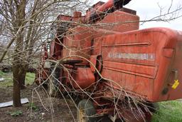 MF combine, salvage- sells w/ partial rack of weights sitting under it