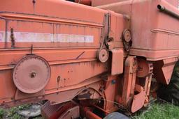 MF combine, salvage- sells w/ partial rack of weights sitting under it