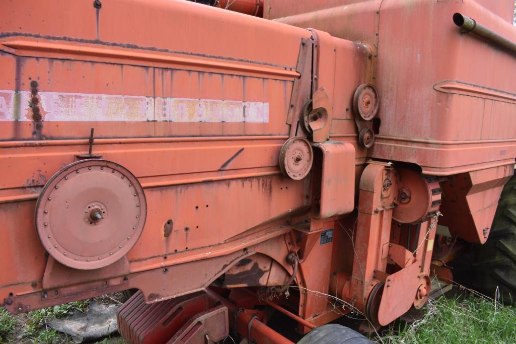 MF combine, salvage- sells w/ partial rack of weights sitting under it