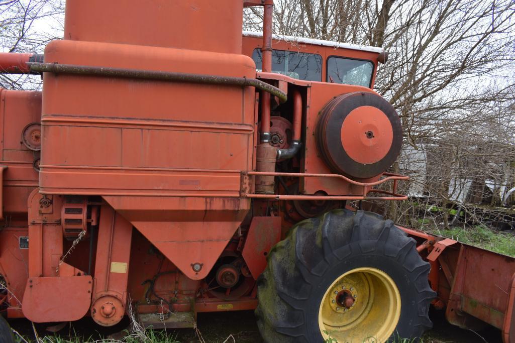MF combine, salvage- sells w/ partial rack of weights sitting under it