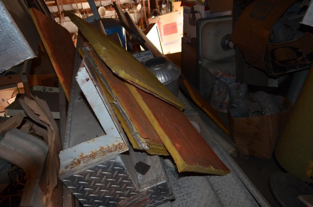Contents in balcony area at south end of building including used diamond tread truck toolboxes, down