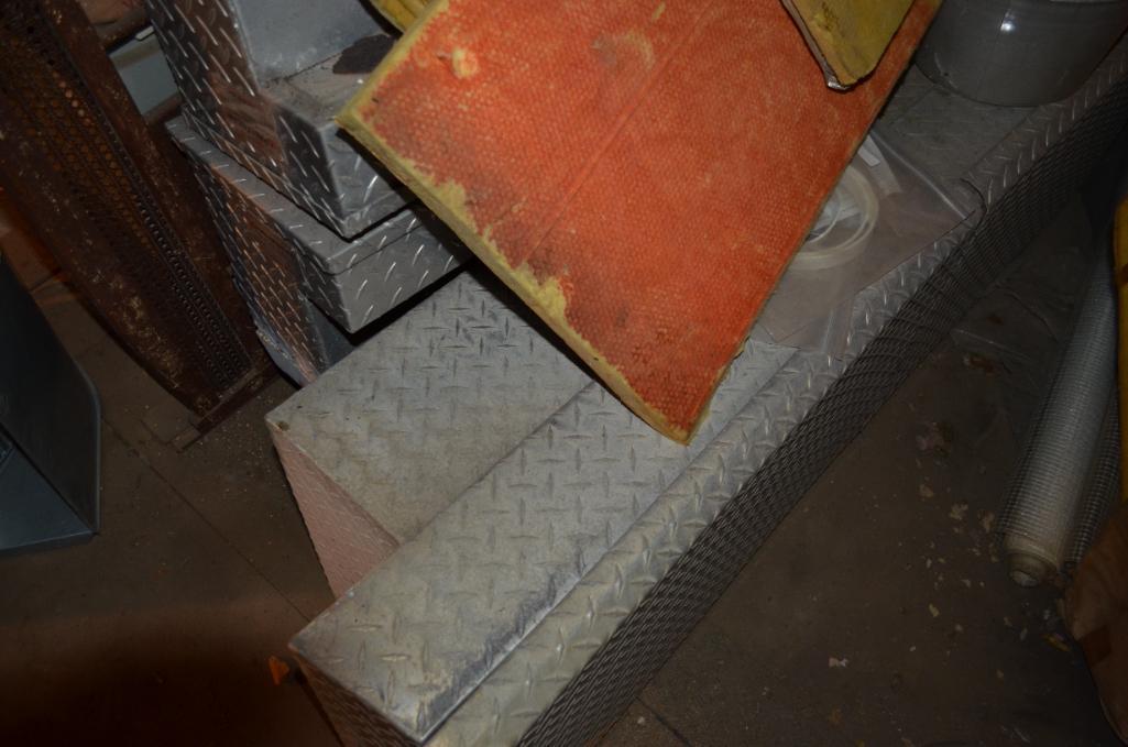 Contents in balcony area at south end of building including used diamond tread truck toolboxes, down