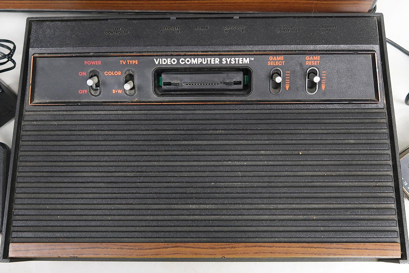 Atari Video Game System, with game center stand, cover (cracked) & 24 cartr