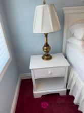 upstairs nightstand with brass lamp