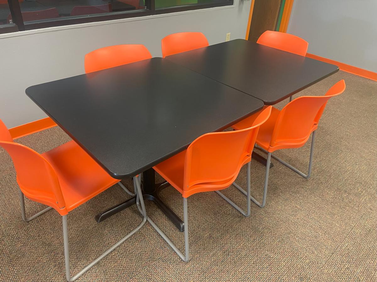 (2) black pedestal dining tables with (6) orange chairs