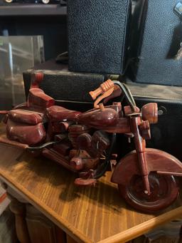 2 collector motorcycles, one Harley one wooden