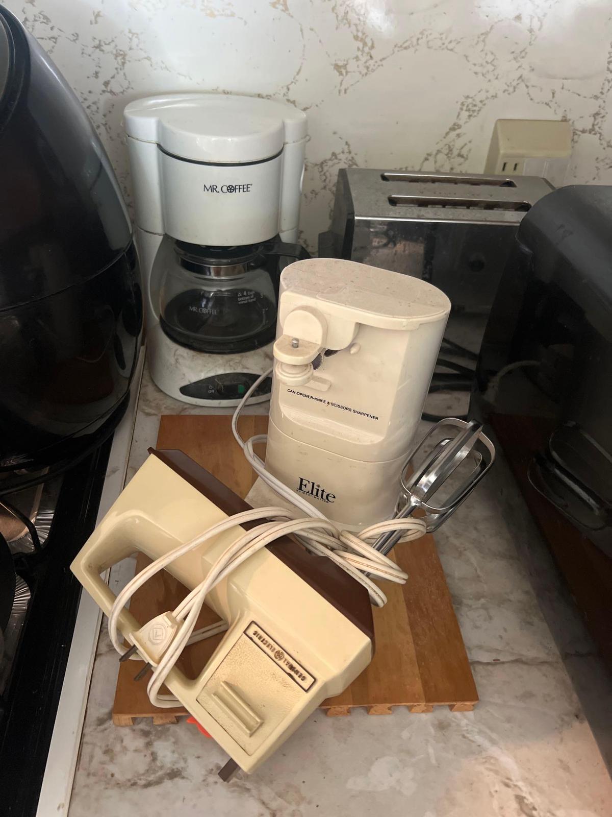 toaster, can opener, coffee pot, and more in kitchen