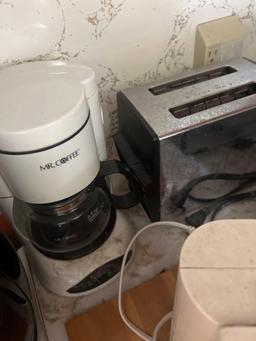 toaster, can opener, coffee pot, and more in kitchen