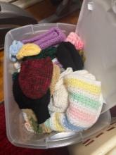 tote of knitted hats blankets