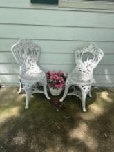 White Plastic outside chairs and flower