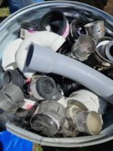 trash can of assorted plumbing fittings