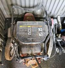 Six horsepower brush trimmer in shed