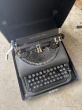 Vintage Remington Rand typewriter with case garage