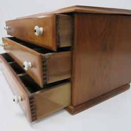 Three drawer walnut primitive table top cabinet