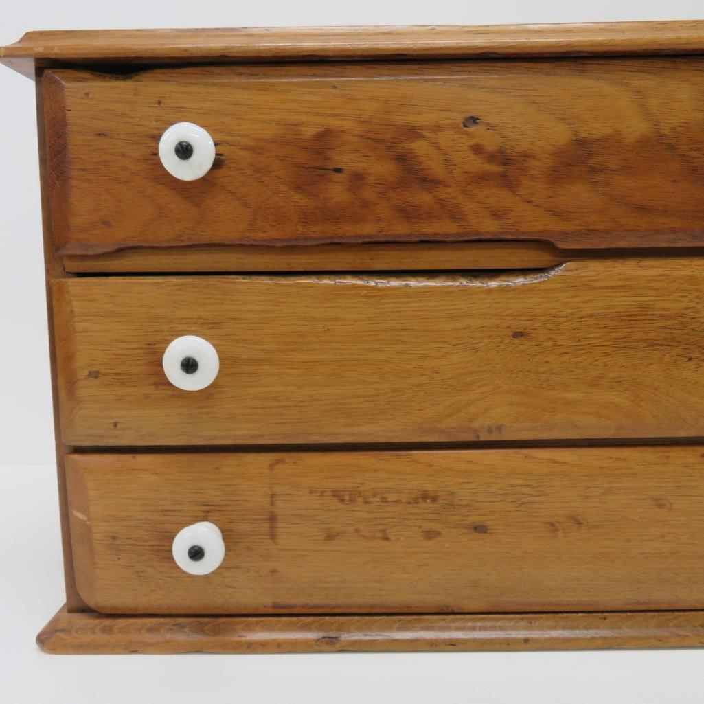 Three drawer walnut primitive table top cabinet