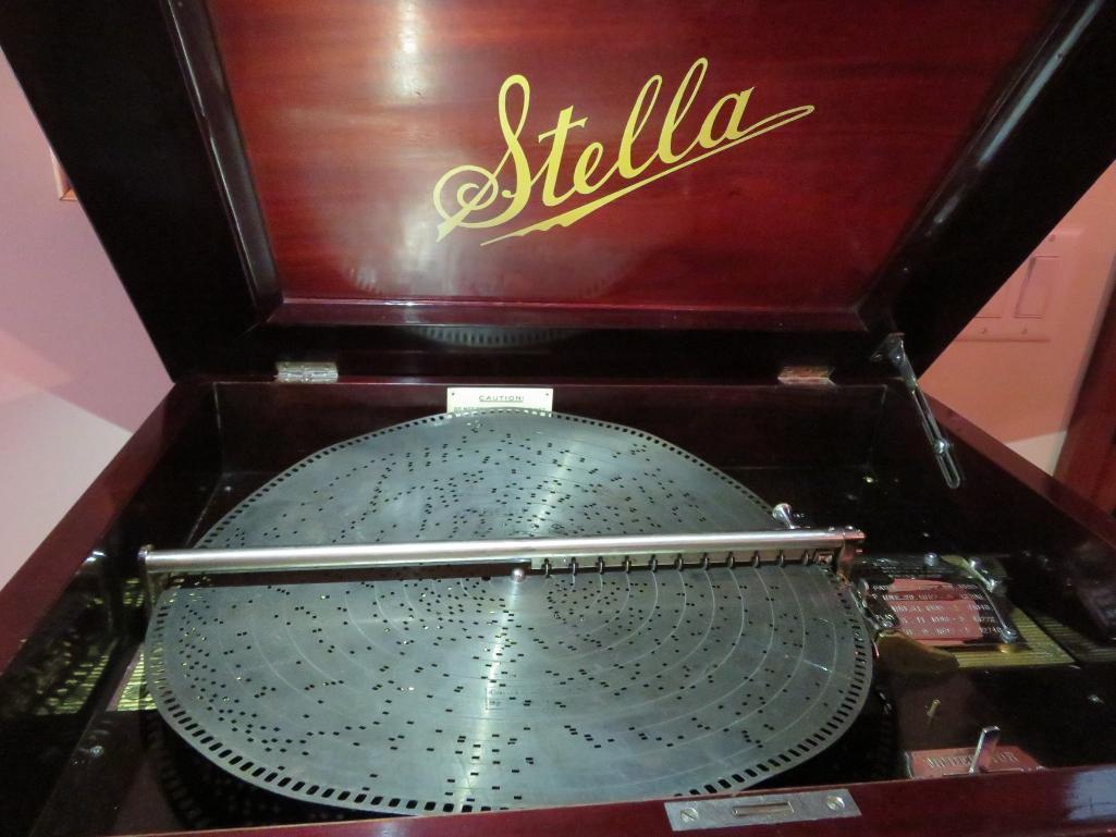 Stella disc music box with 25 discs, 15 1/2" discs, and storage cabinet