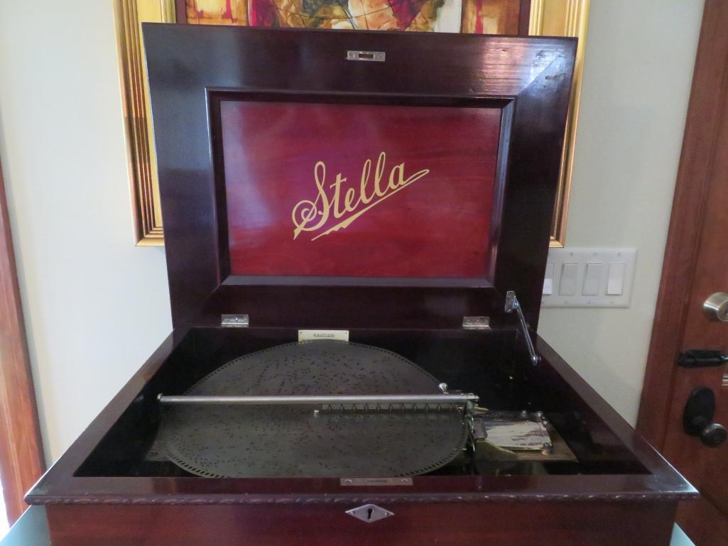 Stella disc music box with 25 discs, 15 1/2" discs, and storage cabinet