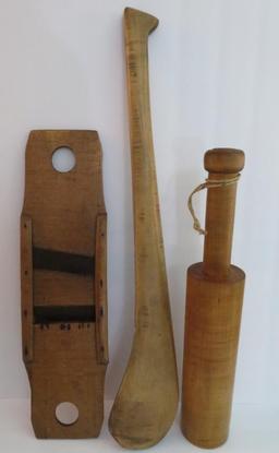 Three large wooden kitchen utensils, paddle, grater and masher,