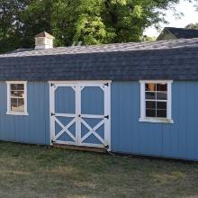 24 X 11 STORAGE BLDG. W/ WOOD SIDING AND BARN DOORS