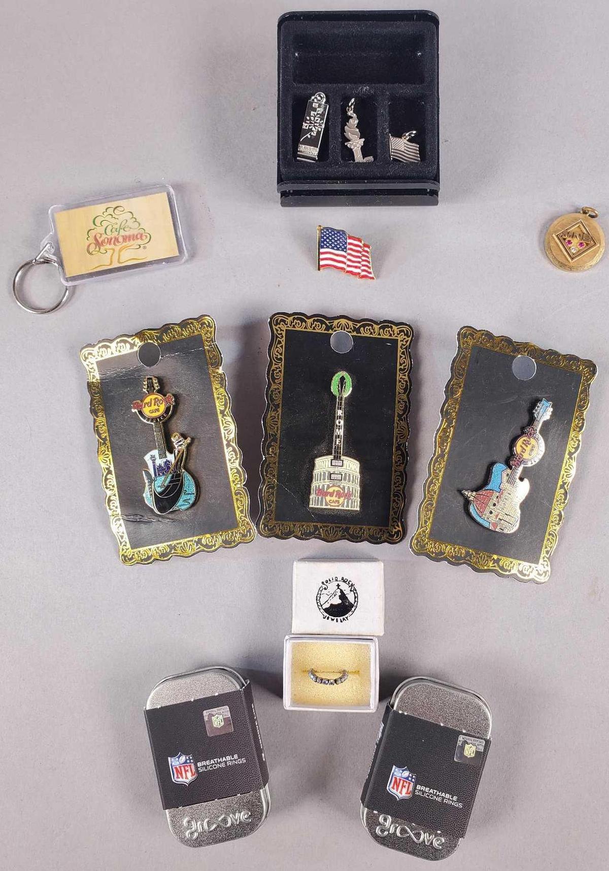 (3) Hard Rock Cafe Lapel Pins, (2) NFL Silicone Rings and More