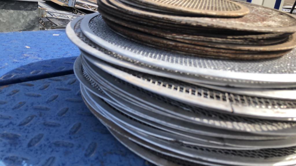Group Of Assorted Sized Perforated Pizza Pans