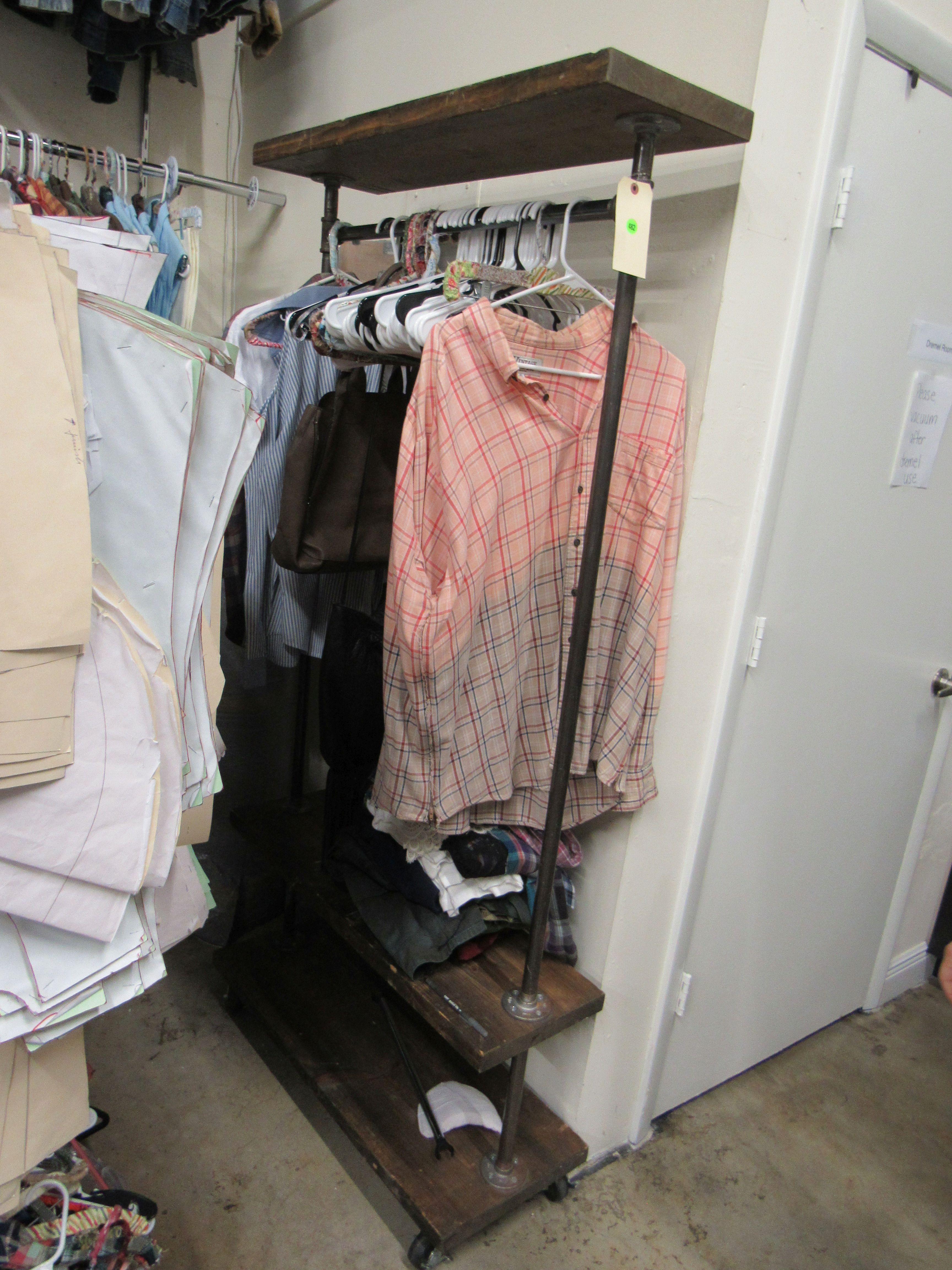 industral style garment rack with wood shelving.  Clothing shown in picture not included.