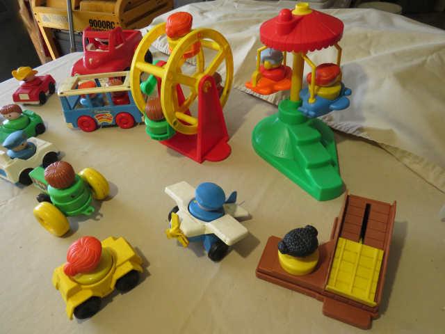 mixed cars and carnival rides with little people - lading machine, Ferris wheel, swing ride, bus, tr