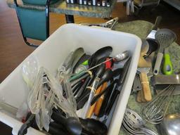 group of utensils including tongs, spatulas, stainless serving spoons, and other commercial service