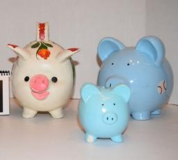 ceramic piggy banks one small blue one medium size blue with baseball design and one white piggy wit