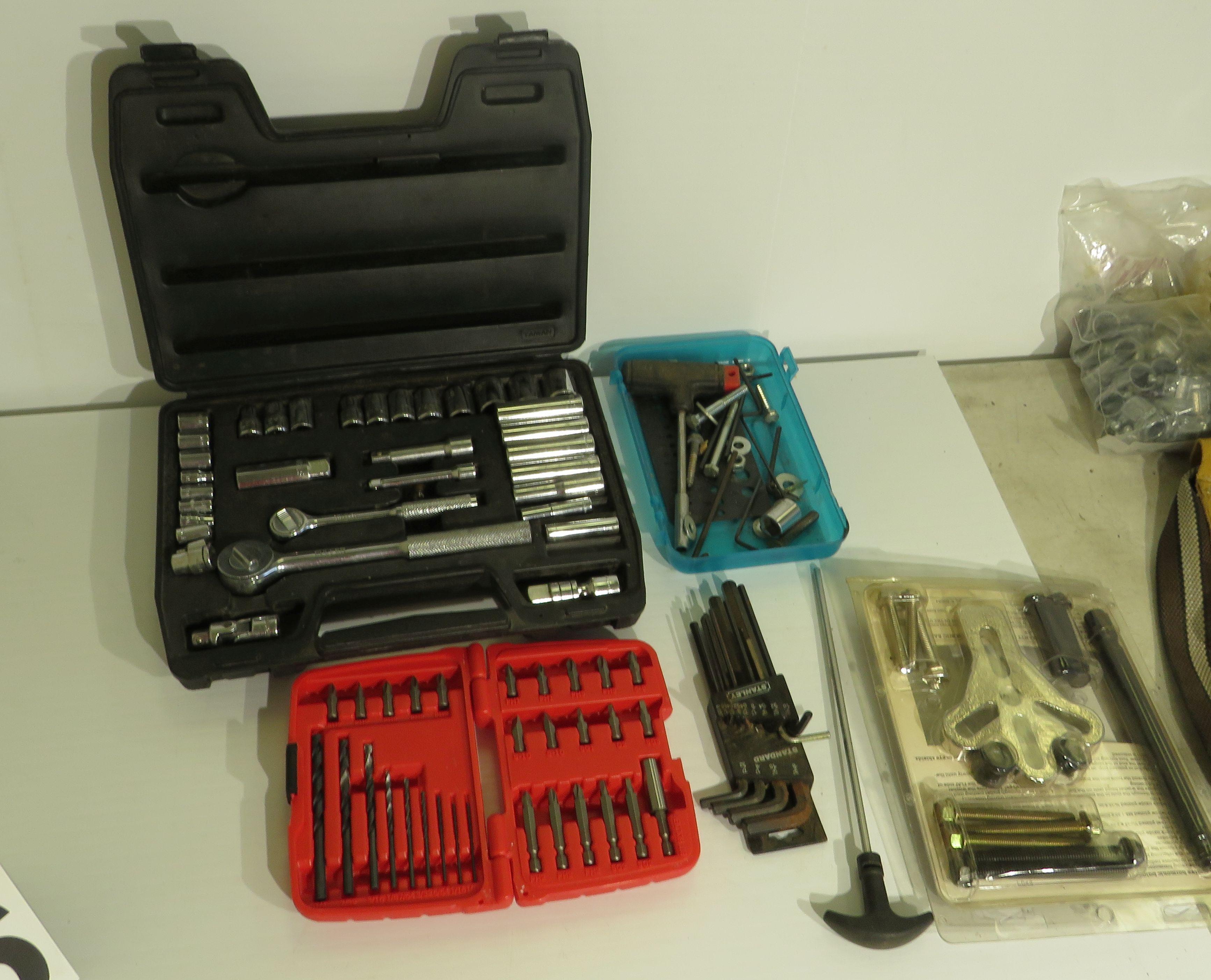 leather contractor bag with mixed tools - drill motor, impact driver, staple gun, trouble light hamm