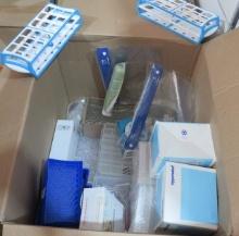 box of mixed lab supplies including pipettes, test tubes, blood collection needles, Dura film