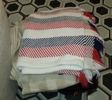 Assorted blankets and linens with container