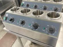 Carnival King heated condiment rail holds four condiment bottles each one with its own individual te