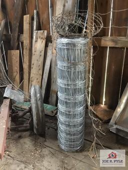 Lot in corner: old frame with wheels and tires, metal fencing, etc.
