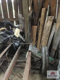 Lot in corner: old frame with wheels and tires, metal fencing, etc.