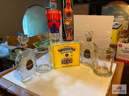Four vintage liquor decanters, two glass beer pitchers, Twisted Tea bar display