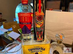 Four vintage liquor decanters, two glass beer pitchers, Twisted Tea bar display