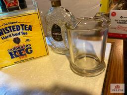 Four vintage liquor decanters, two glass beer pitchers, Twisted Tea bar display
