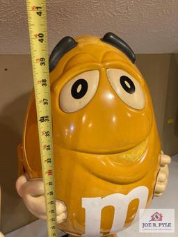 2 M & M store displays on wheels Orange 37" x 24" x 17" and yellow 41" x 18" x 17"
