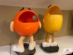 2 M & M store displays on wheels Orange 37" x 24" x 17" and yellow 41" x 18" x 17"