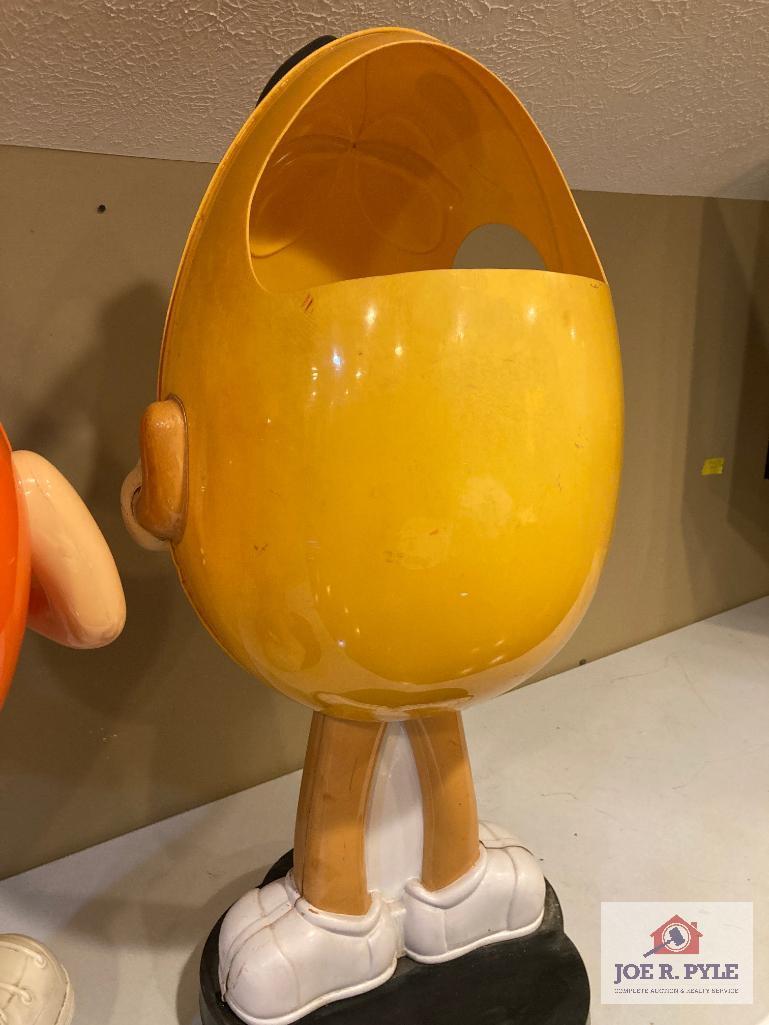 2 M & M store displays on wheels Orange 37" x 24" x 17" and yellow 41" x 18" x 17"
