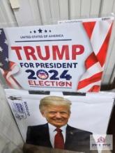 Trump signs and life size cardboard cut-out of Donald Trump