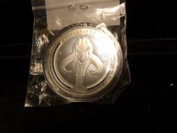 Baby Yoda "The Child" Star Wars Tribute Coin in capsule.